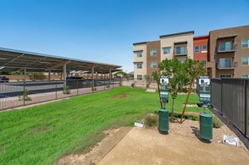 A sunny day at a residential area with apartment buildings and a parking area.